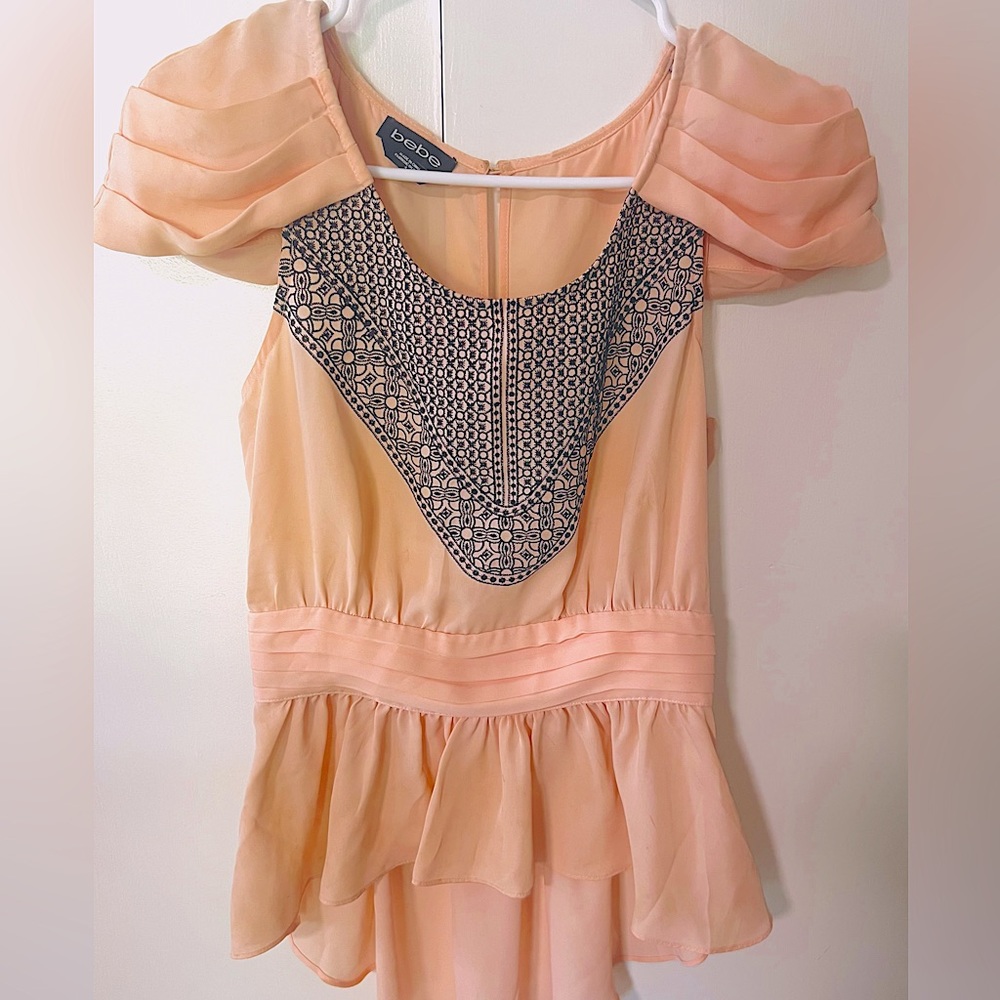 Bebe light pink blouse with elegant and chic design. Size 4.